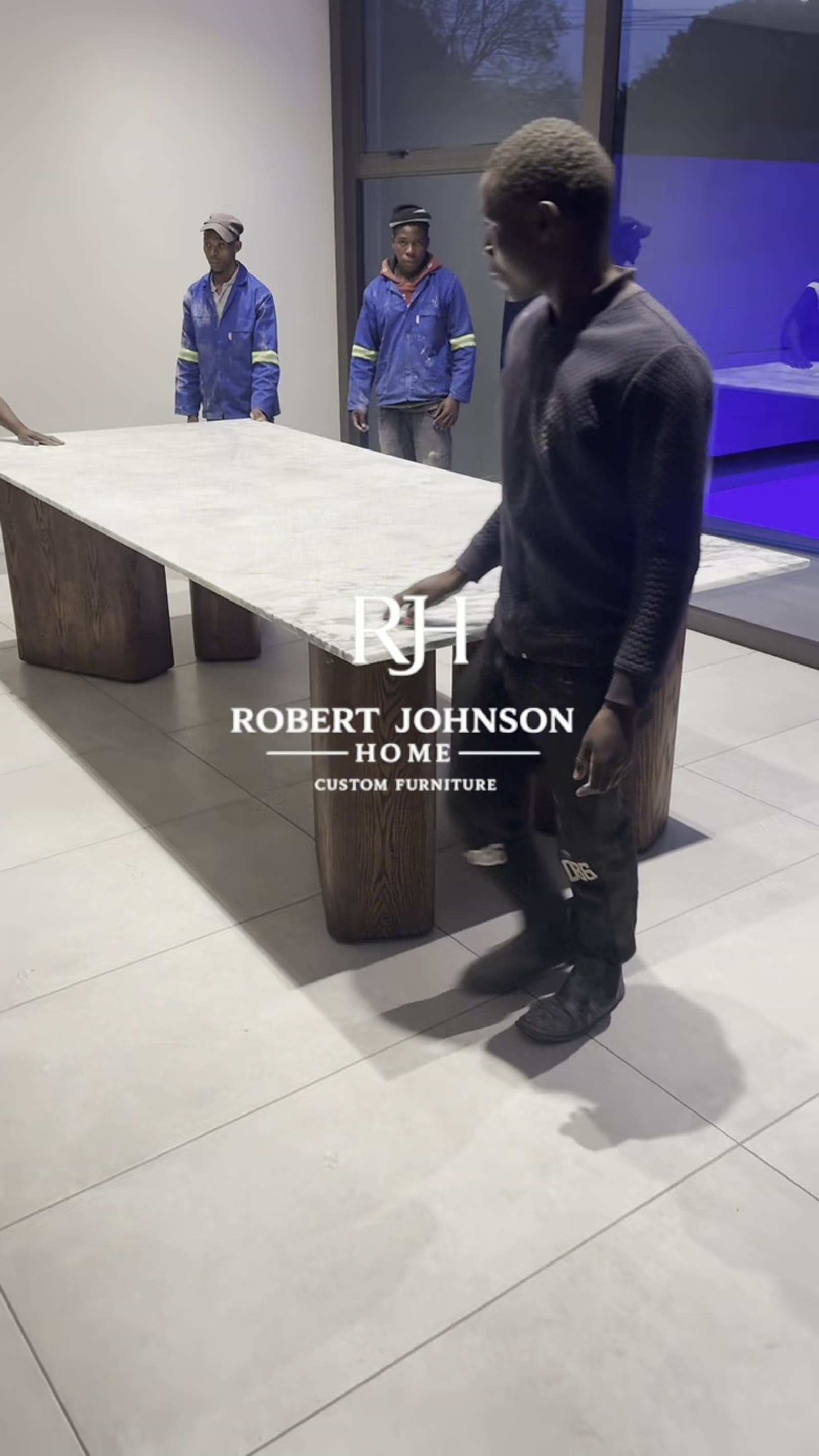 The team setting up a dining table in the showroom