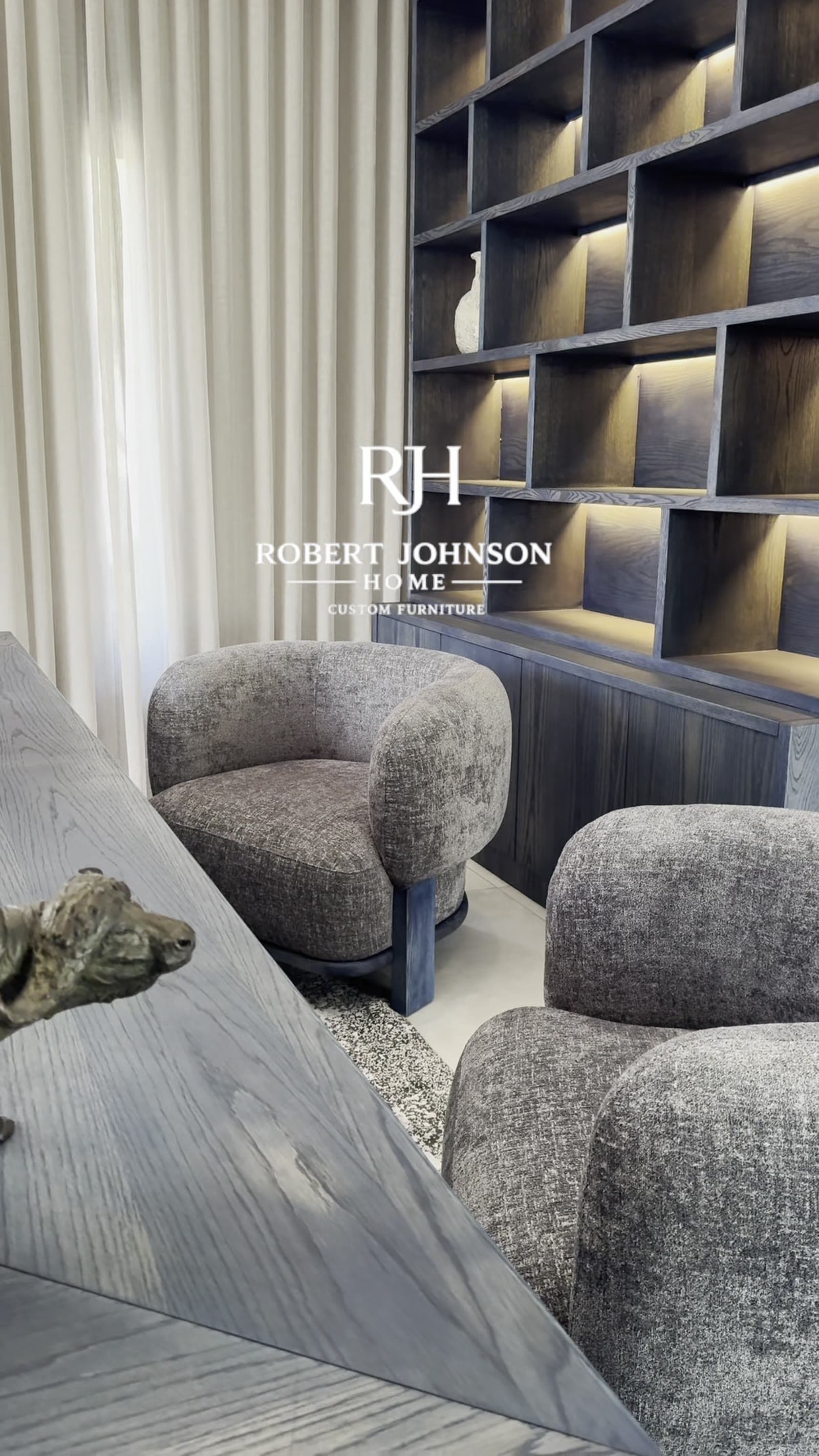 The Harcourt Armchair — A curved-back accent chair on a solid timber base.